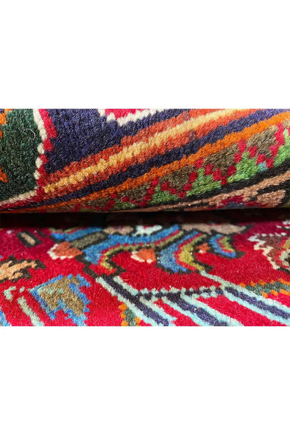 Close-up of a carpet edge with a multicolored ornamental pattern and dense pile