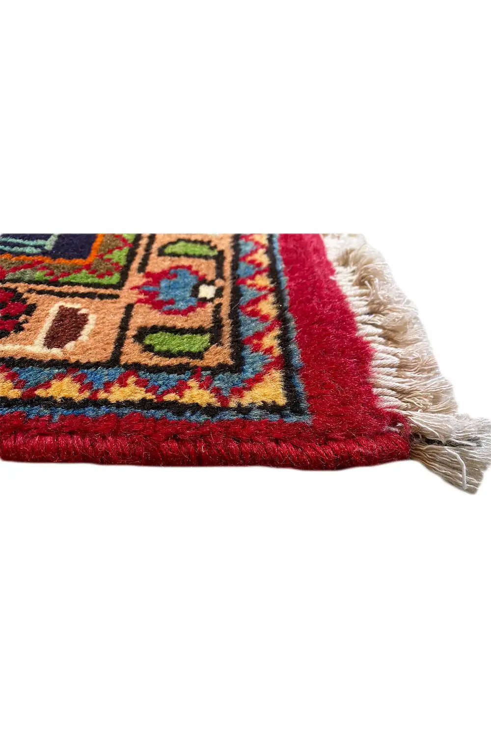 Carpet edge with red fringes and a colorful pattern along the border