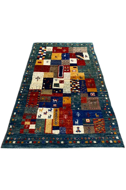 Gabbeh rug (127x79 cm) in blue with geometric patchwork and various motifs