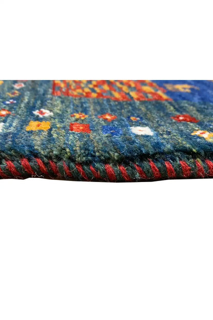 Gabbeh rug (127x79 cm), close-up of the edge with multicolored trim and fringes