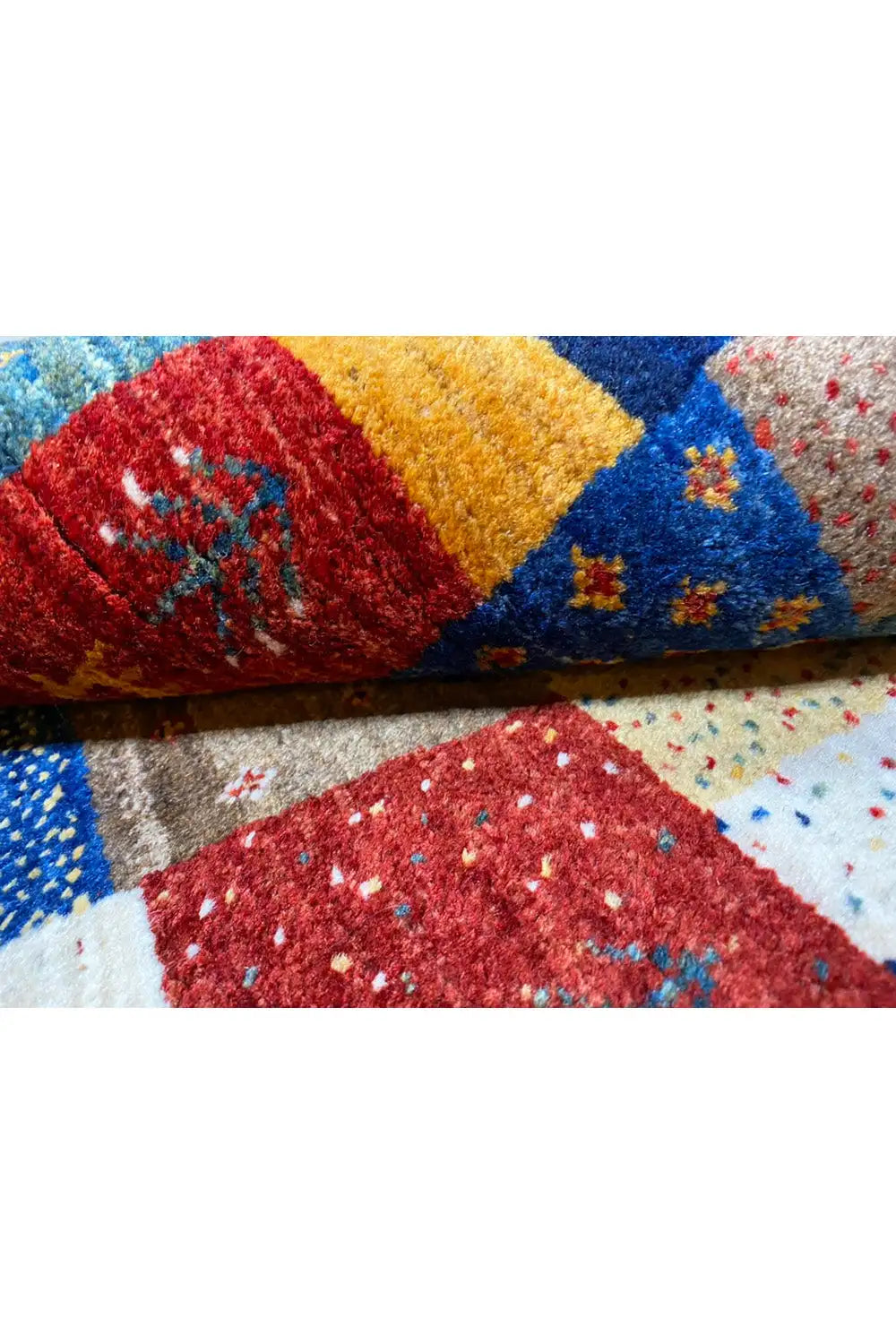 Gabbeh rug (127x79 cm) close-up: colorful pile with red, yellow, and blue areas