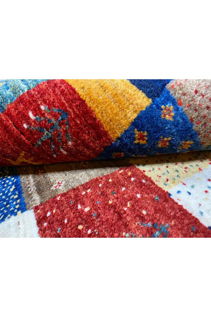 Gabbeh rug (127x79 cm) close-up: colorful pile with red, yellow, and blue areas
