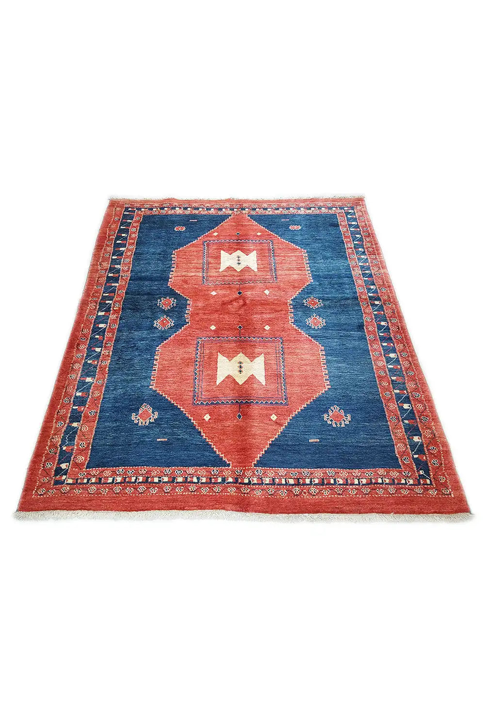Rug with a blue background, orange-red areas, and a multi-part medallion design