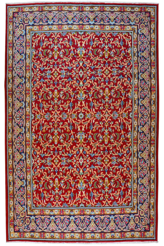 Kerman rug with a red central field and blue-and-gold border, rectangular