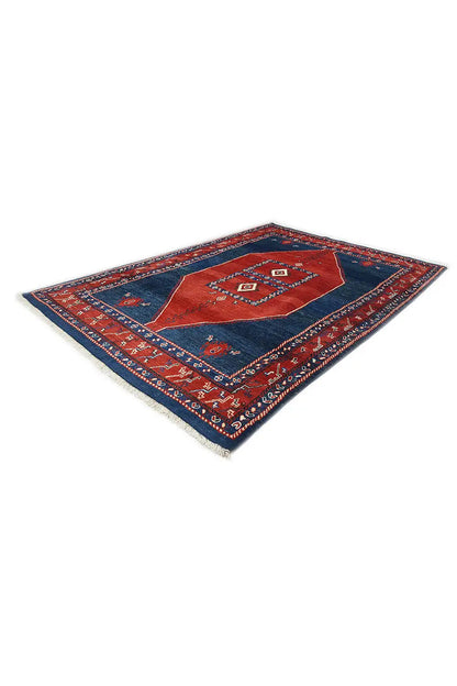 Oriental-style rug with a blue background, red central motif and multicolored decorative border