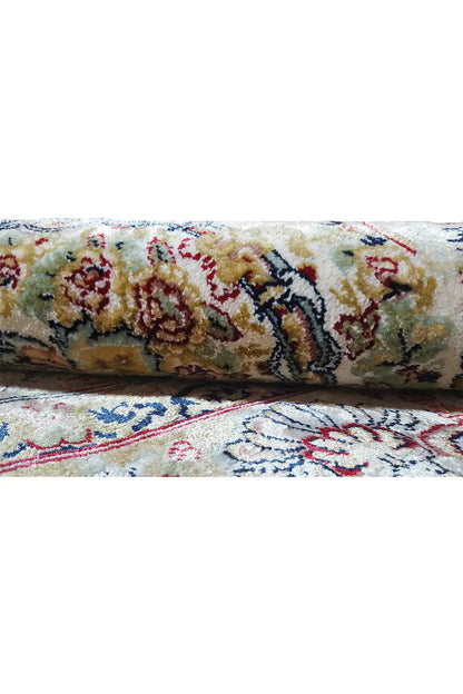 Close-up of machine-woven carpet: floral pattern, multicolored details, high pile