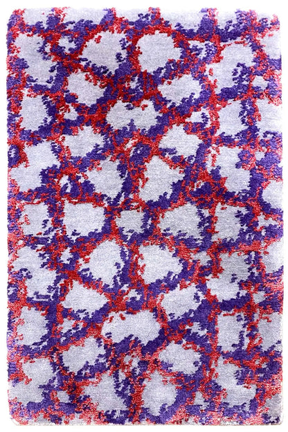 Rectangular rug with an abstract pattern in blue, red, and purple on a light background.