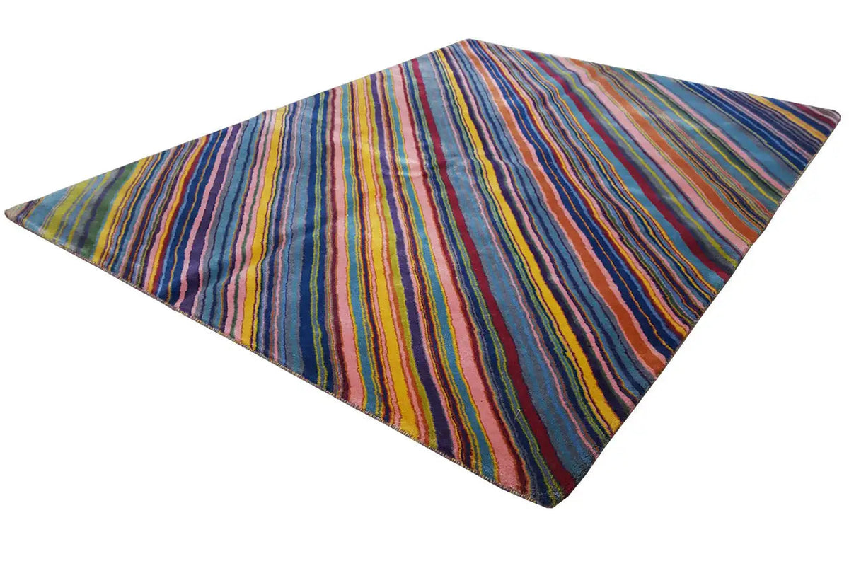 Rug with a multicolored striped pattern, spread out in a triangular shape