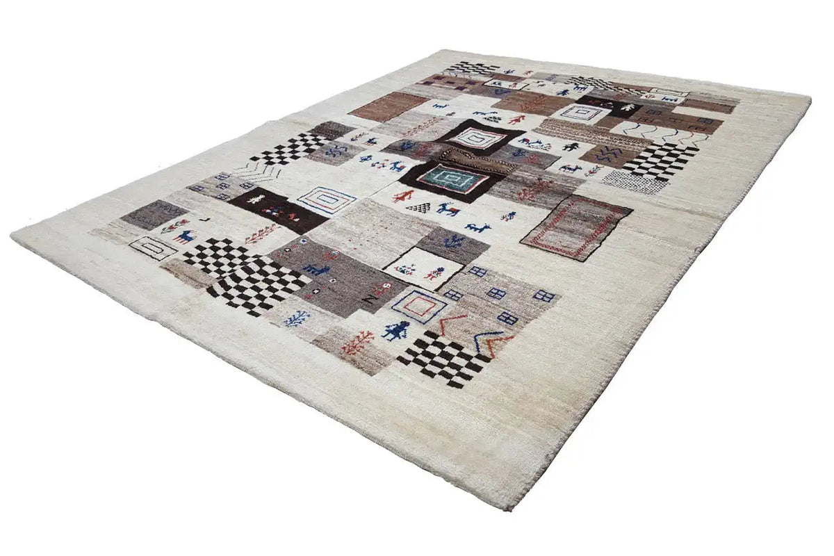 Gabbeh rug, rectangular, light base with a geometric patchwork pattern in blue and brown.