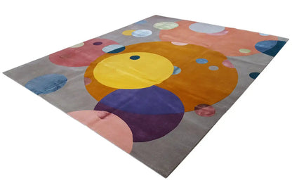 Rug with a colorful polka-dot pattern on a gray background, abstract circles and shapes