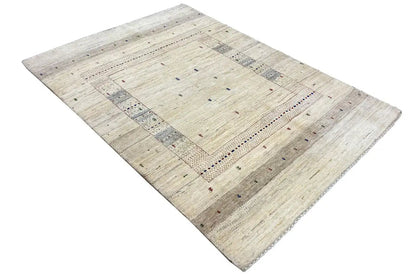 Gabbeh rug in a light beige shade with a geometric border featuring colorful accents