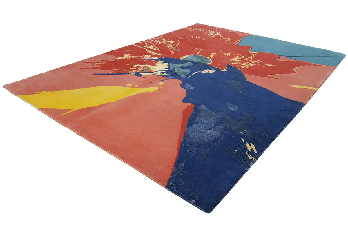 Rug with an abstract splash design in orange, blue, and yellow, laid out diagonally