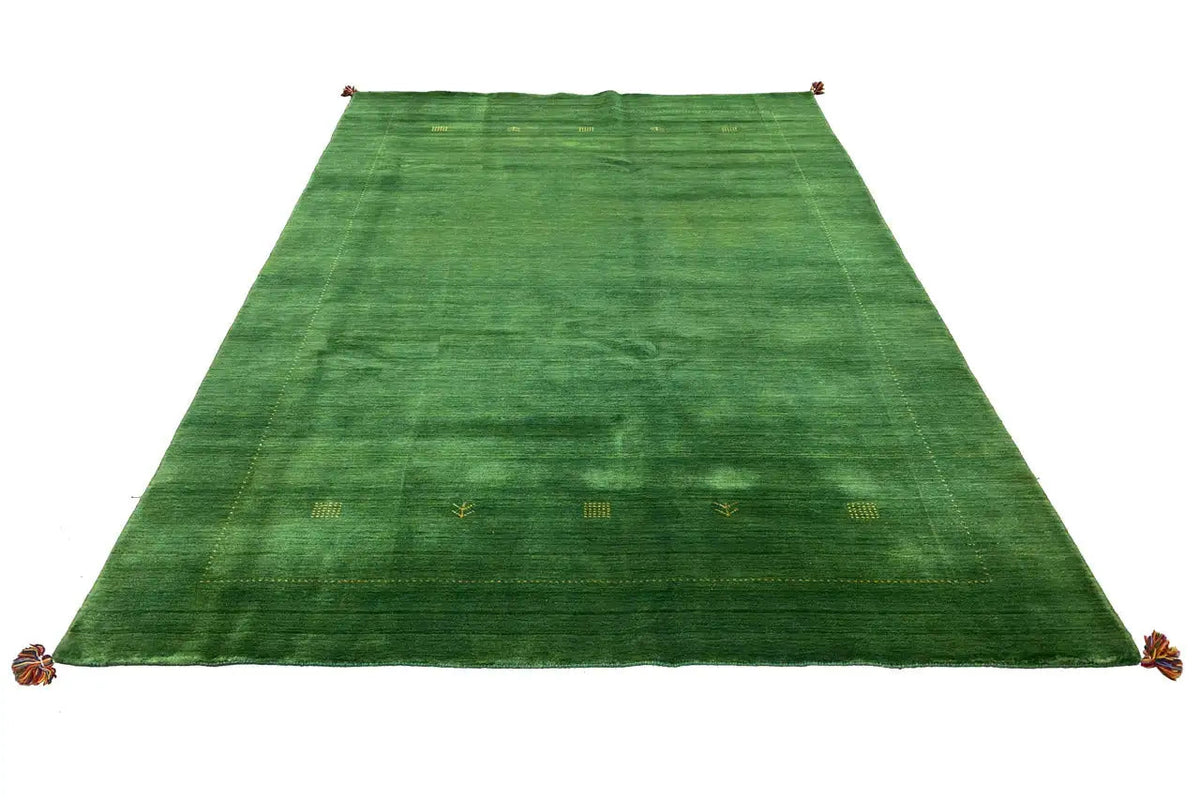 Rectangular green Gabbeh rug with an all-over pattern and tassels at the corners