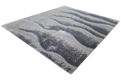Beach rug 154x183 cm, diagonal view: gray wave pattern with blue accents.