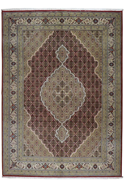 Indo Tabriz rug with central medallion, red ornamentation, and blue border