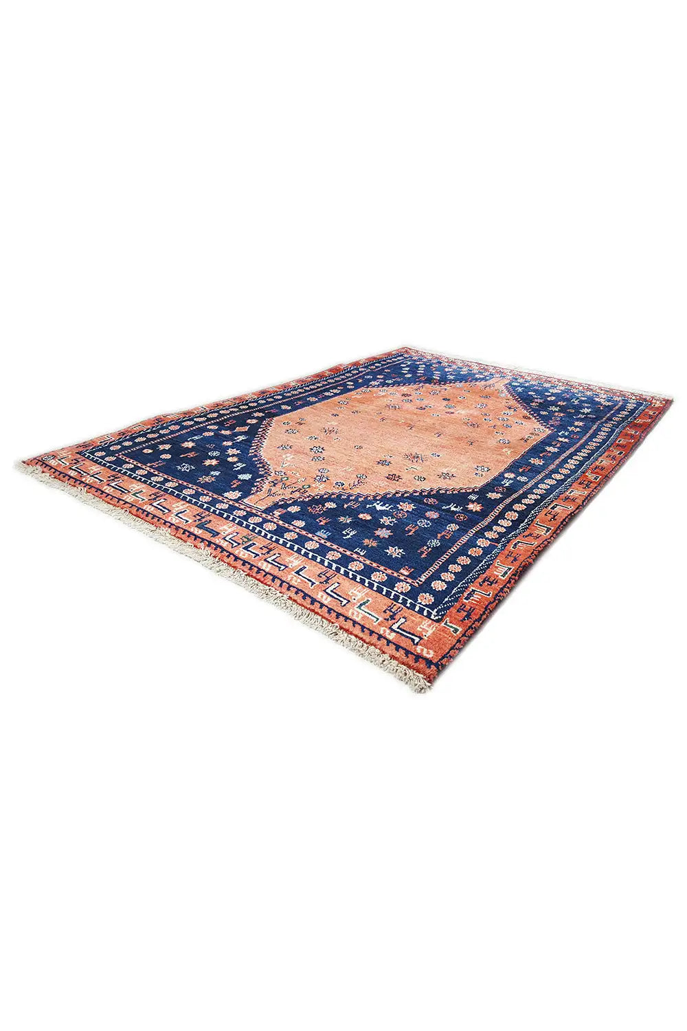 Oriental rug corner view with a blue field, orange medallion, and borders