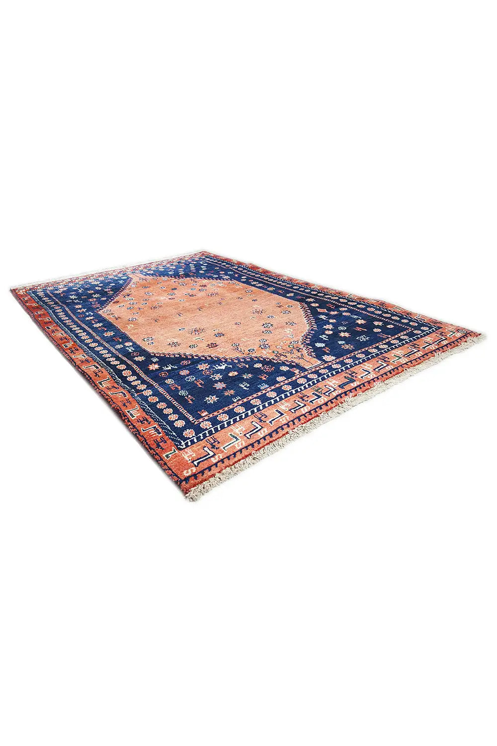 Oriental rug corner view with blue border, orange central medallion, and patterned border