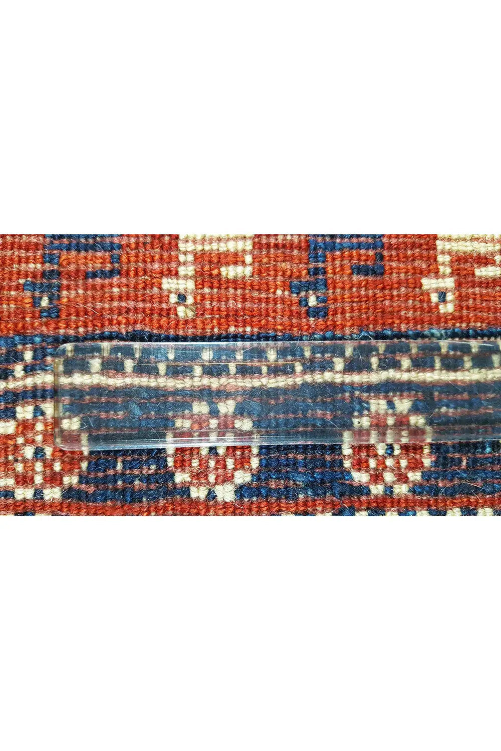 Rug border detail: blue pattern with orange stripes and decorative bands