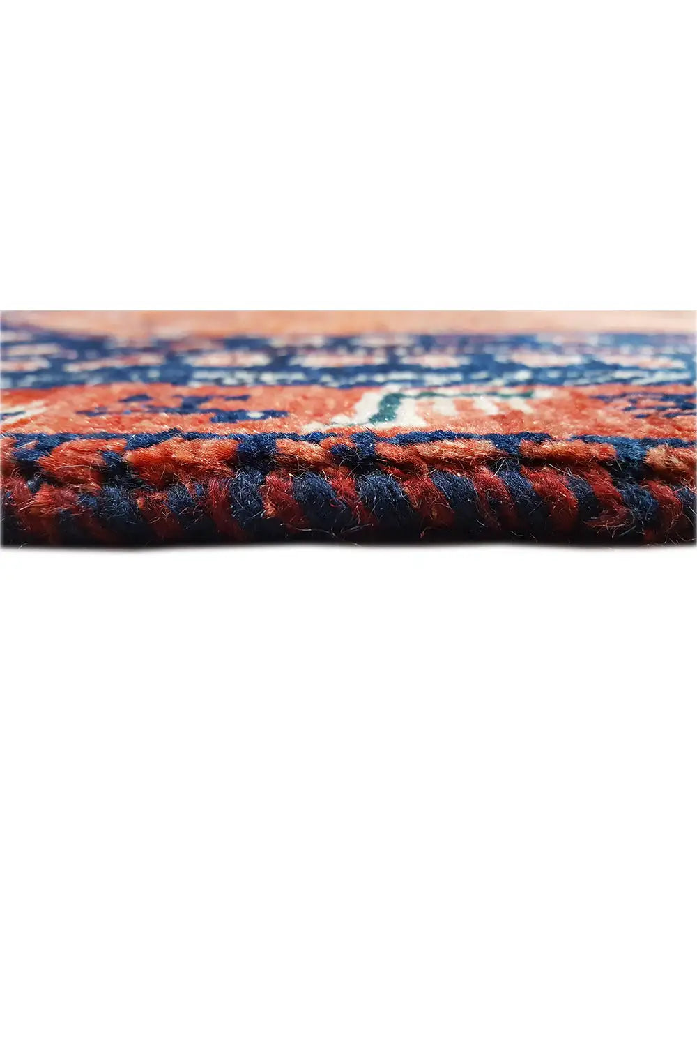 Carpet edge with a colored woven border and dense, multicolored pile