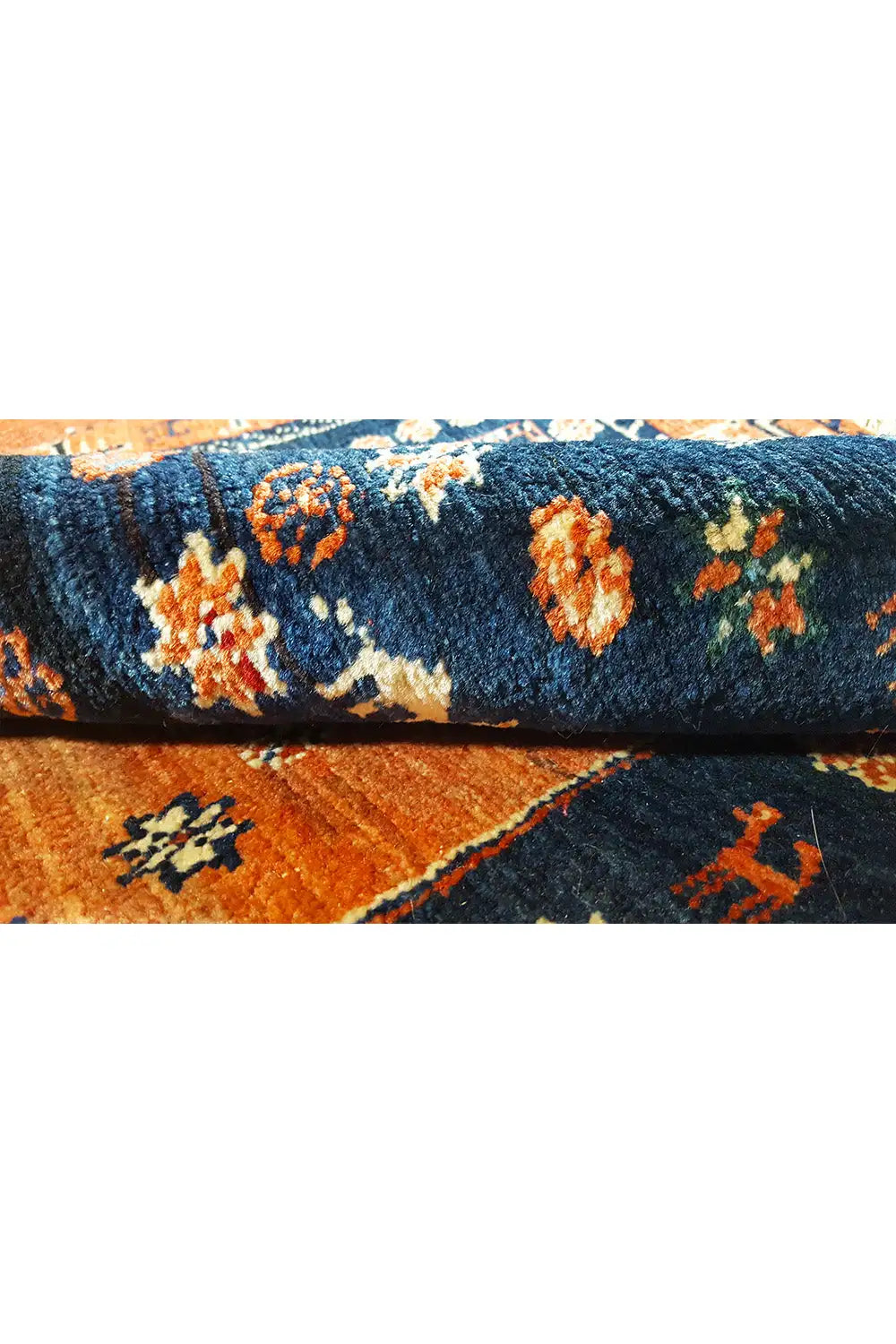 Carpet pile with colorful floral motifs on a blue background