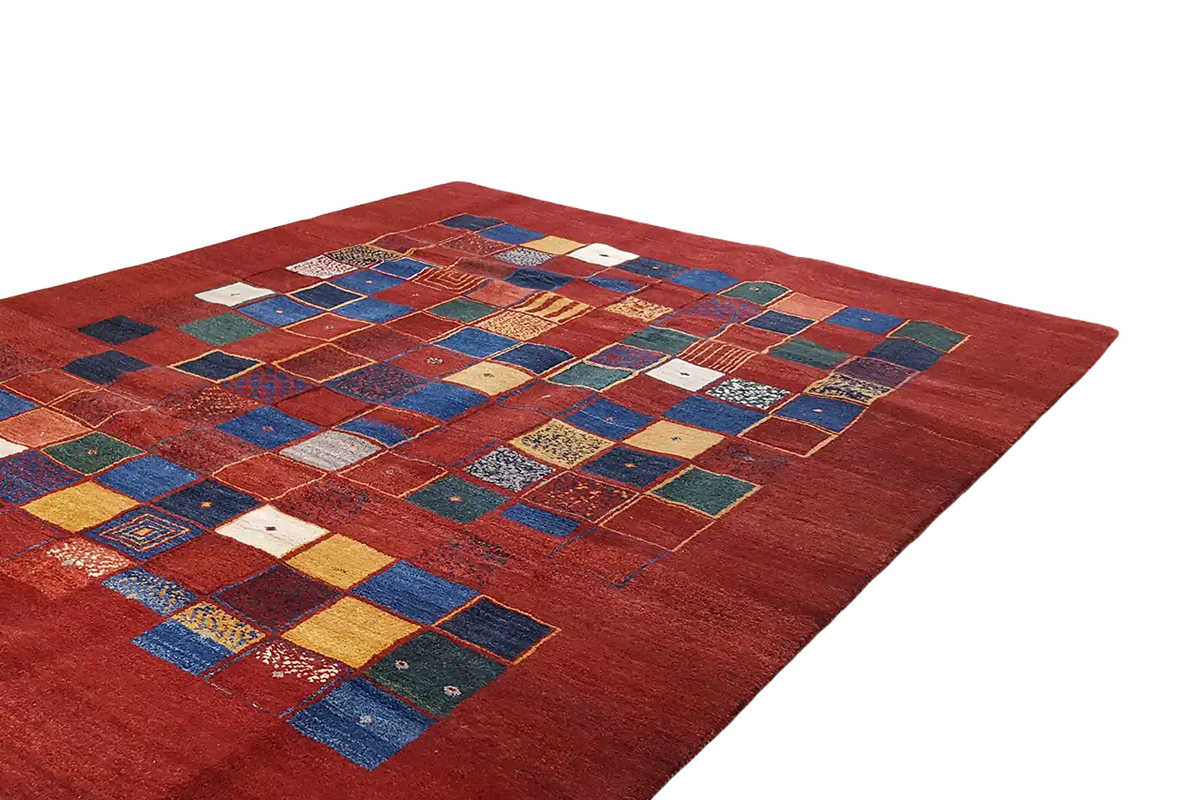 Red gabbeh rug with blue-and-yellow patchwork squares