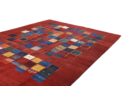 Red gabbeh rug with blue-and-yellow patchwork squares