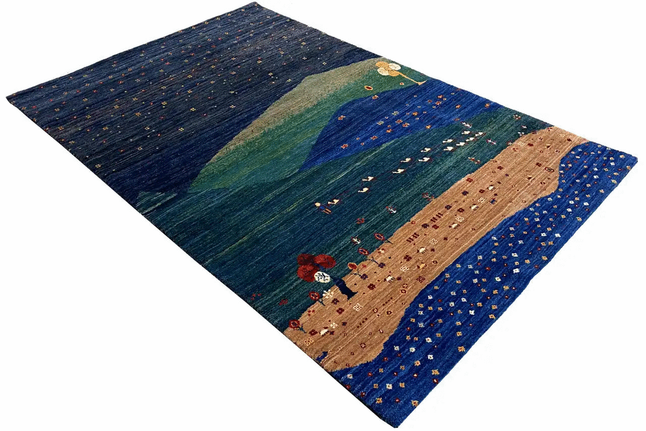Carpet with a landscape design in blue, green, and beige, photographed at an angle