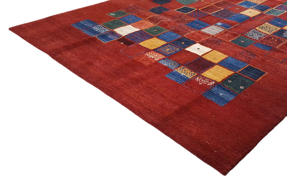 Gabbeh rug: red background with geometric patchwork of tiles