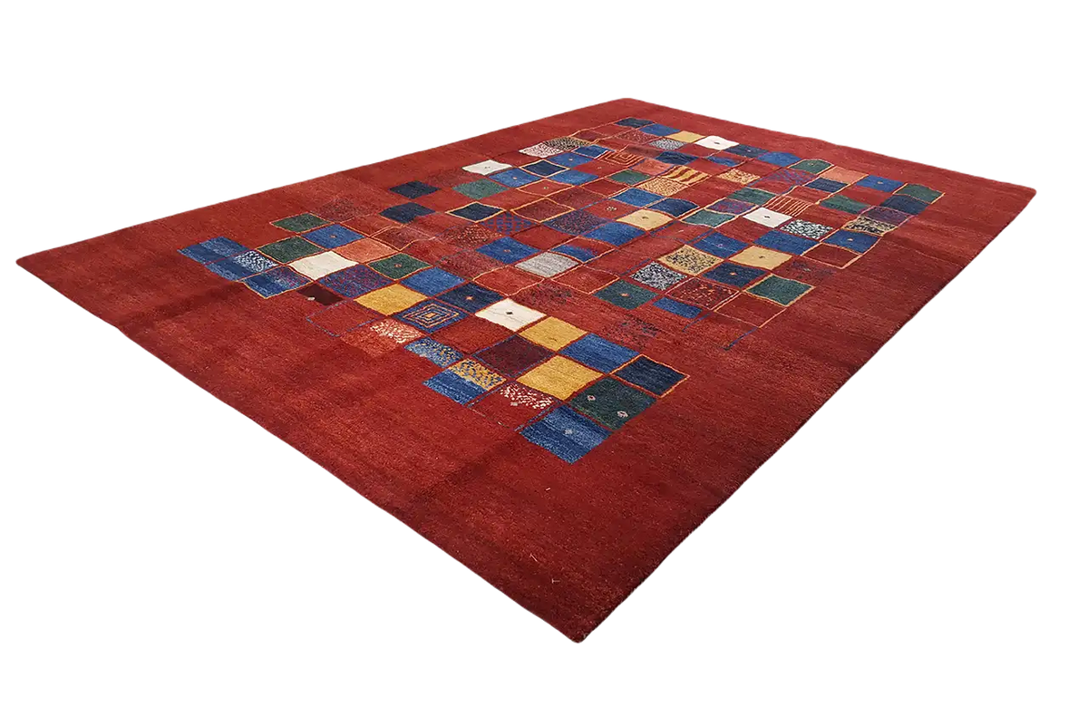 Gabbeh rug with a pattern of colorful squares on a red background