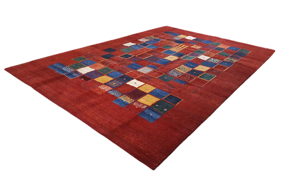 Gabbeh rug with a pattern of colorful squares on a red background