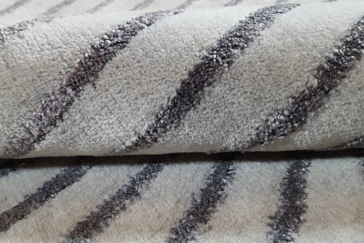 Rug detail: gray pile with a dense, darkly outlined line pattern