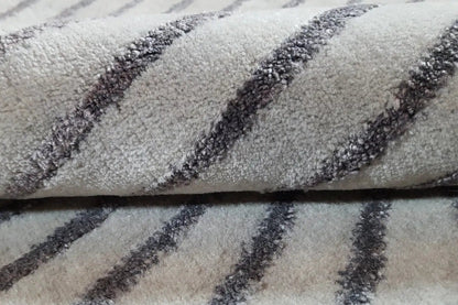 Rug detail: gray pile with a dense, darkly outlined line pattern