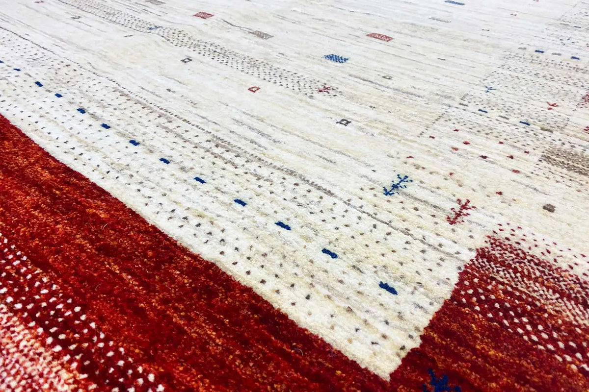 Gabbeh rug detail: cream-colored field with dotted, multicolored micro-motifs