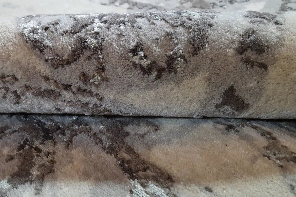 Rug surface in detail: short pile with a medallion pattern in brown and gray
