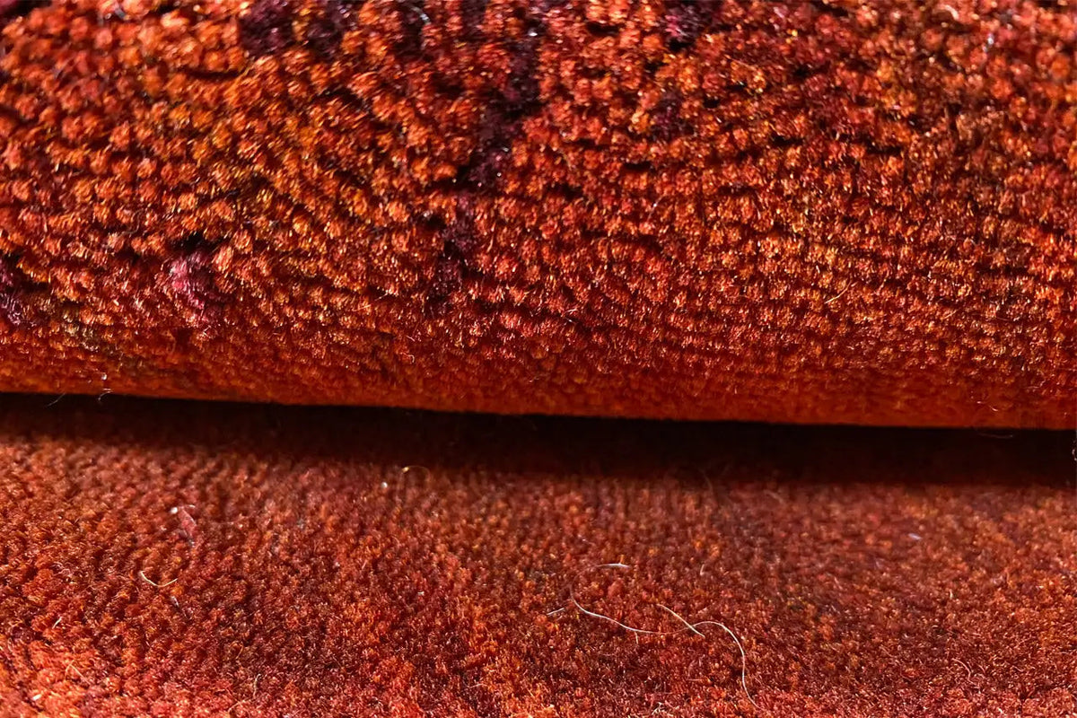 Gabbeh rug: reddish-brown pile texture in close-up, densely woven