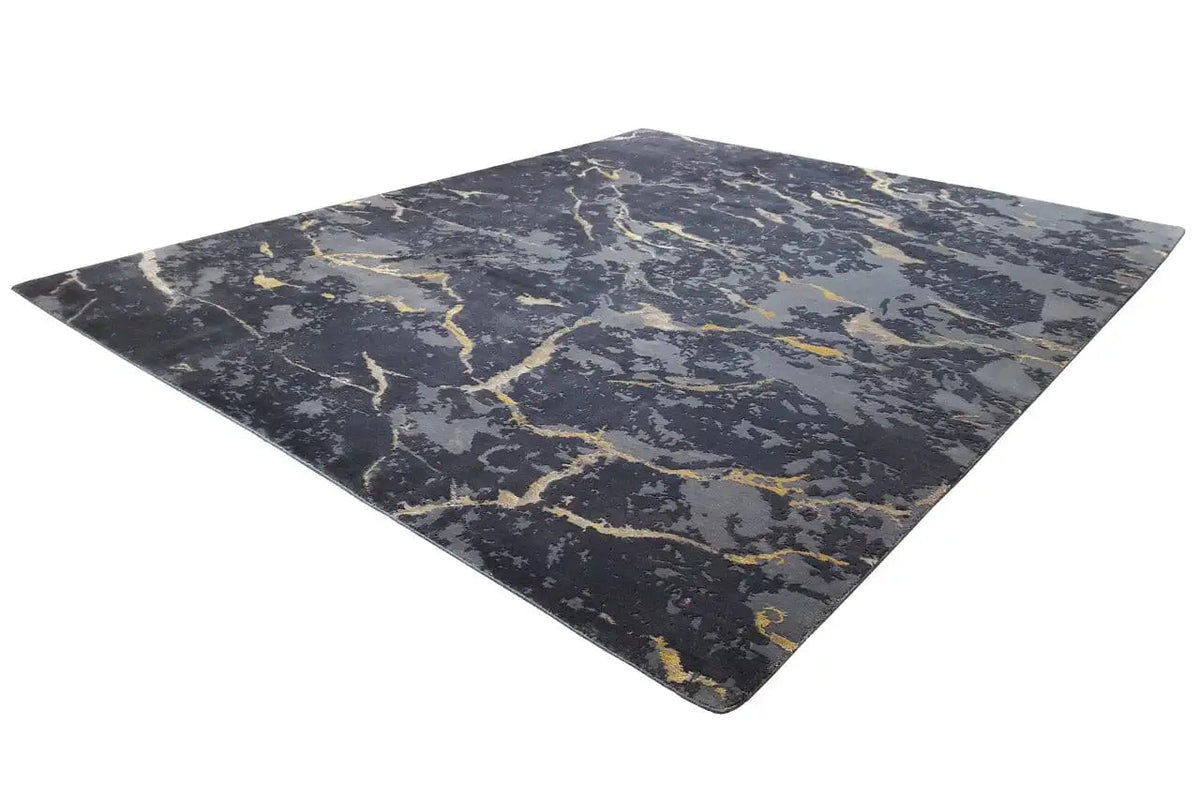 Dark gray carpet with yellowish marble-like lines viewed at an angle