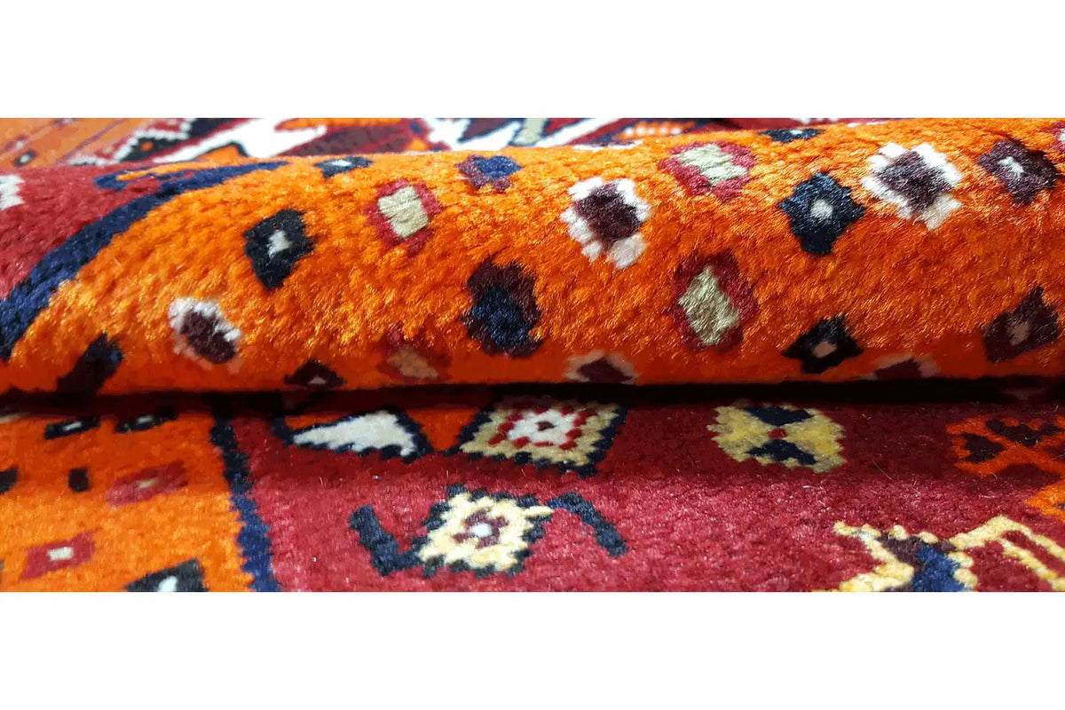 Carpet detail: orange-bordeaux pile with black and white dots and ornaments