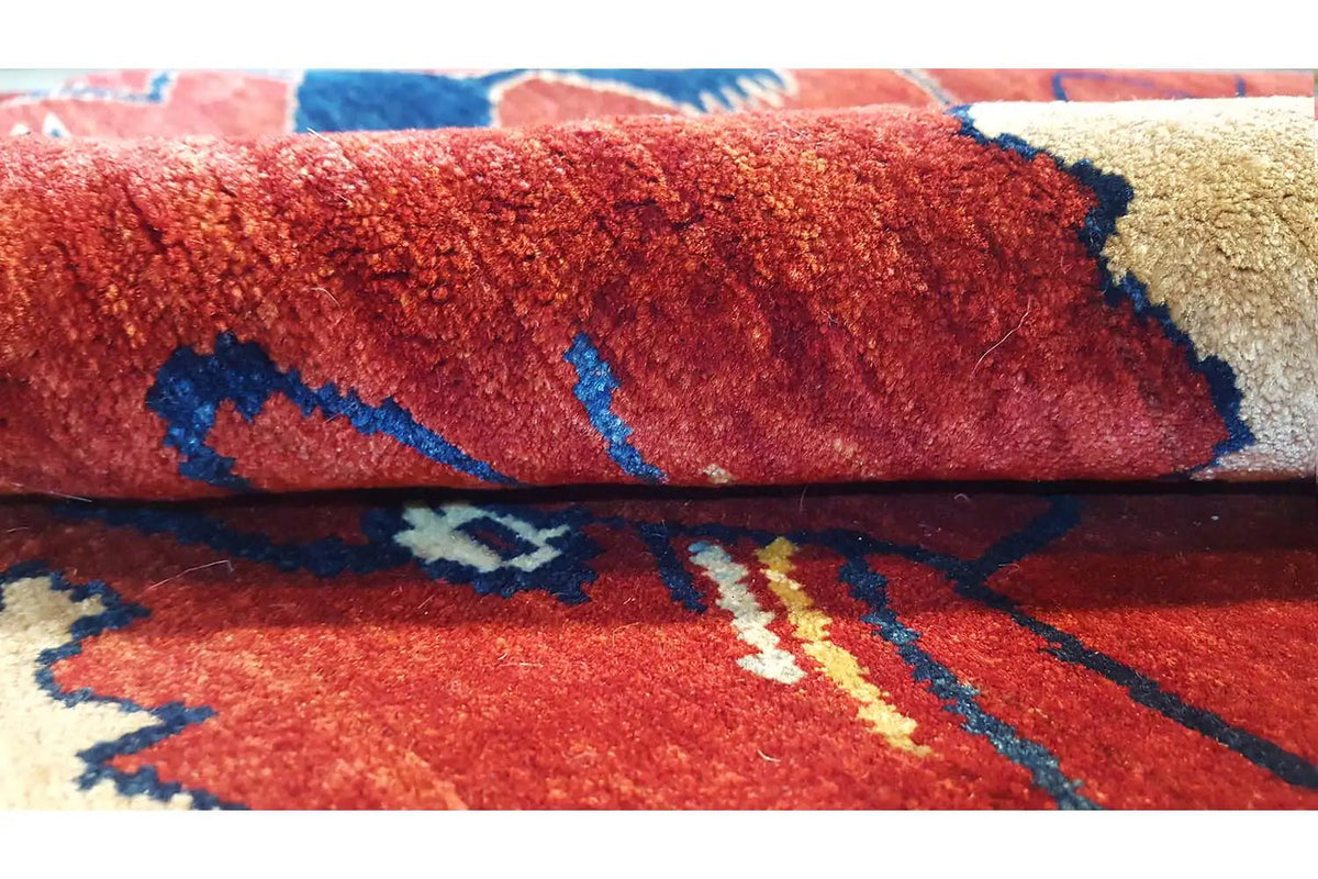 Close-up: red carpet with a blue pattern and beige accents