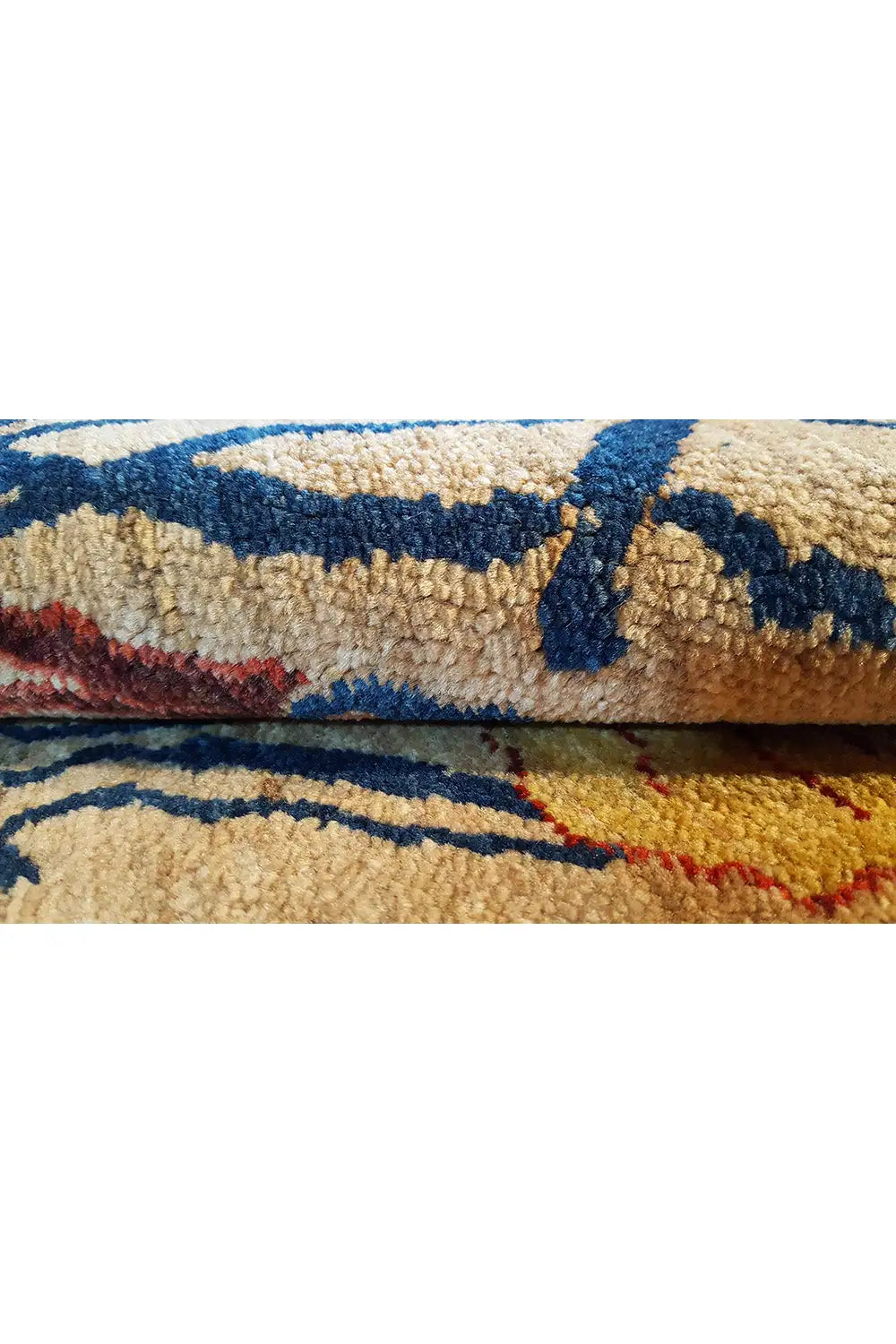 Carpet detail, visible pile, and fabric edge with a multicolored blue and red pattern