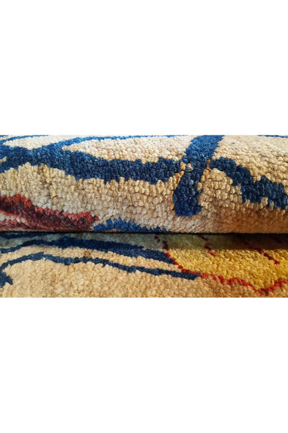 Carpet detail, visible pile, and fabric edge with a multicolored blue and red pattern