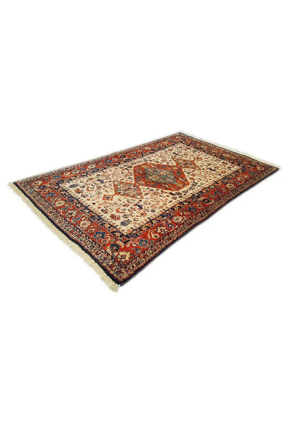 Rug with a cream-colored center and reddish-blue ornament borders