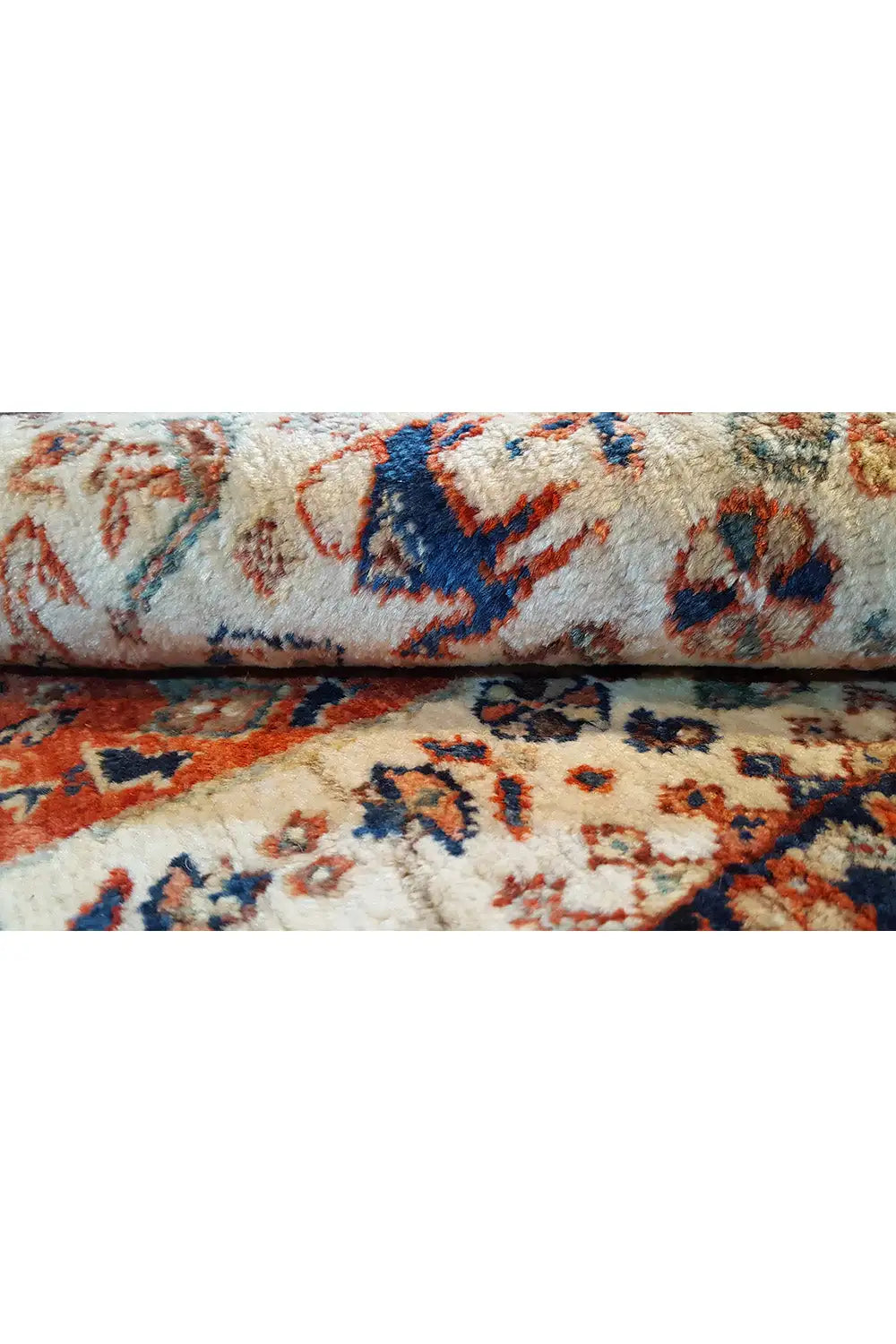 Carpet edge in detail, multicolored embroidery patterns and short-pile surface