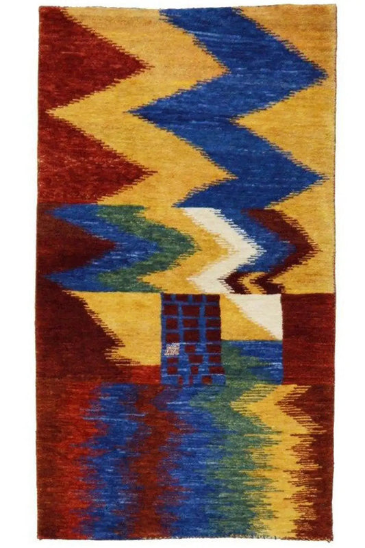 Gabbeh rug with a geometric zigzag pattern in red, blue, yellow, and green