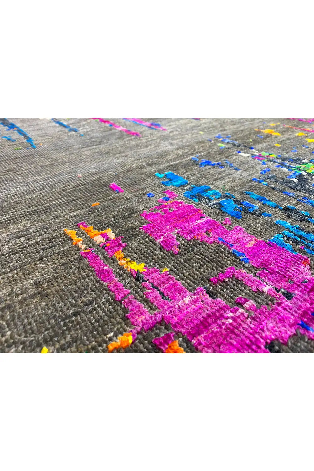 Close-up: bold pink and blue pattern with colorful dots on gray fabric.
