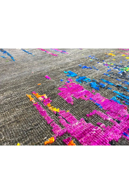 Close-up: bold pink and blue pattern with colorful dots on gray fabric.