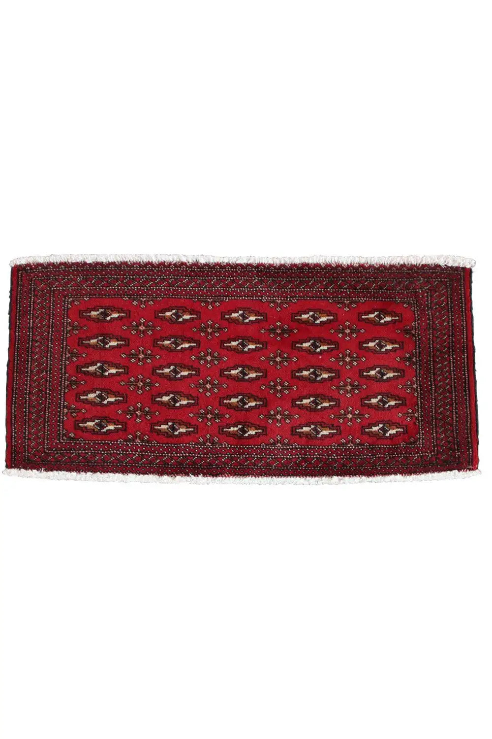 Rectangular Turkmen carpet, red with a central field pattern and white fringes along the edge