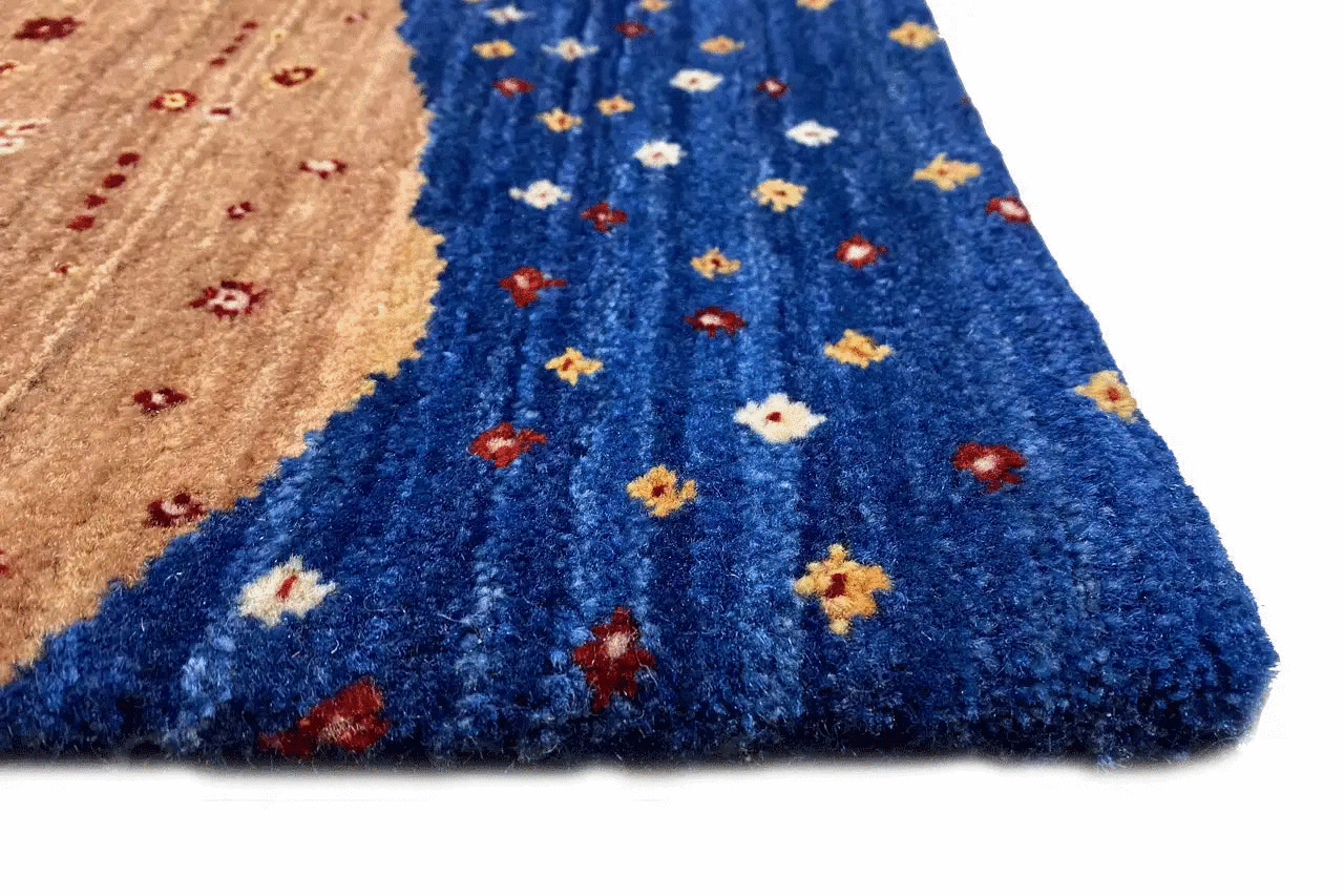 Carpet pile in detail: blue pattern with multicolored dots and beige section