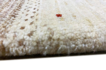 Close-up of Lori Gabbeh rug: soft pile texture in light beige with a brown contrasting border