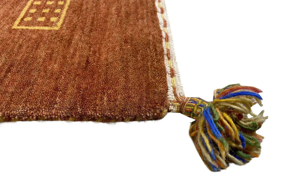 Gabbeh flatweave rug with fringe along one edge and a patterned inset