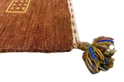 Gabbeh flatweave rug with fringe along one edge and a patterned inset